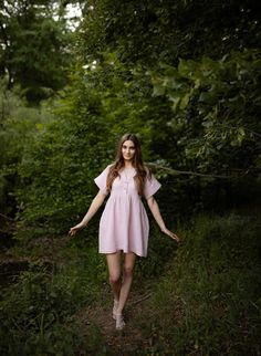 Short dress made of high quality double gauze fabric. Front fastening with 2 cocounut buttons. Short  sleeve. Side pockets.  Loose fit. Matching belt at the back. The model in Lt. Pink dress is wearing size S/36. She is 70"/178 centimeters height (bust 34"/86cm , waist 26 1/2"/68cm , hips 35 1/2"/90cm ) The model in Lt. Yellow Pudding dress Is wearing size S/36. She is 66 1/2", 169 centimeters height (bust 32,5"/83cm , waist 25"/63cm , hips 35,5"/90cm ) The model in Grape dress is wearing size S Flowy Short Sleeve Shirt Dress For Daywear, Flowy Short Sleeve Shirt Dress, Linen Short Sleeve Mini Dress For Summer, Summer Linen Mini Dress With Short Sleeves, Linen Short Sleeve Mini Dress, Short Sleeve Linen Mini Dress For Beach, Short Sleeve Linen Dress For Beach, Short Sleeve Linen Dress With Buttons For Day Out, Summer Dresses With Short Sleeves And Buttons