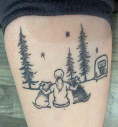 a tattoo on the leg of a person with trees and a camper in the background