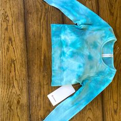 This Top Is Super Smooth And Soft! It Is Like A Blue And Turquoise Tie Dye Color. It’s In Size 4 And Is Cropped. I Have Never Worn It And The Tags Are Still Attached! It Is Limited Edition Blue Athleisure Activewear With Thumbholes, Blue Fitted Top For Pilates, Fitted Blue Top For Pilates, Fitted Blue Activewear With Thumbholes, Light Blue Fitted Activewear For Light Exercise, Fitted Light Blue Activewear For Light Exercise, Lululemon Pastel Blue, Lululemon Blue Swiftly, Light Blue Long Sleeve Sports Top