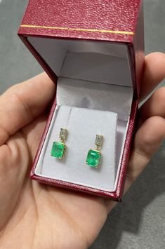 Displayed is a stunning pair of emerald and diamond, dangle earrings. Two gorgeous Colombian emerald-emerald cuts totaling a full 3.15-carats, accented by two diamond baguettes. Set in simple prong settings, allowing for the emeralds and diamonds to be shown in full view. The earth mined, green emeralds have a desirable lush green color with excellent qualities. The perfect drop and dangle earrings. Emerald Cut Earrings, Earrings Emerald, Diamond Baguette, Emerald Earrings Studs, Diamond Dangle Earrings, Colombian Emeralds, Emerald Earrings, Emerald Jewelry, Baguette Diamond