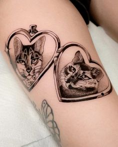 two pictures of cats in heart shaped frames on the thigh, one is black and white