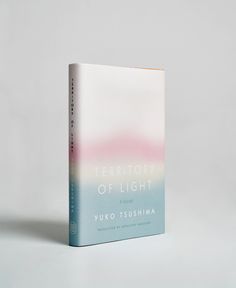 a book with the title territory of light written in blue, pink and green on it