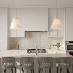 a kitchen with four stools and an island in the middle, surrounded by white cabinets