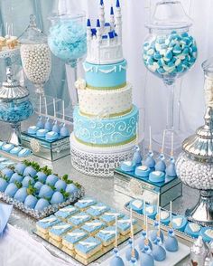 a table topped with lots of blue and white desserts