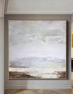 a large white painting hanging on the wall