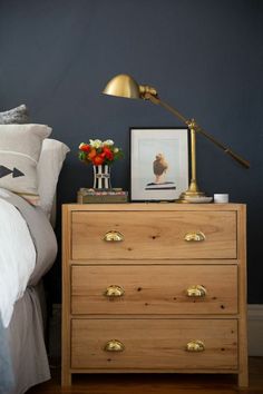 a bedroom with blue walls and wooden furniture