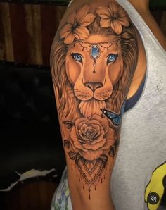 a woman with a lion tattoo on her arm