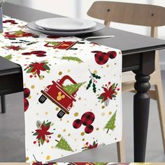 a table topped with a white plate covered in christmas decorations