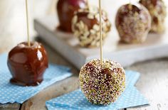 caramel apples with sprinkles and chocolate drizzled on them