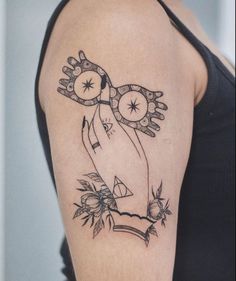 a woman's arm with a clock and flowers tattoo on her left upper arm