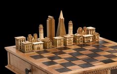 a wooden chess board with buildings on it