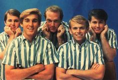 an advertisement for the beach boys featuring four men in striped shirts and one is holding his head