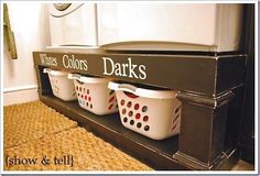 three white laundry baskets sitting on top of a shelf next to a washer and dryer