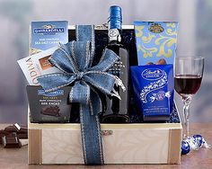 a wine and chocolate gift basket with a glass of wine