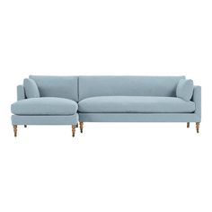 a light blue couch with wooden legs