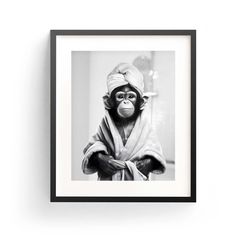 a black and white photo of a monkey wrapped in a towel with his arms crossed