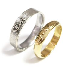 two wedding rings with the word love engraved on each one, both in gold and silver