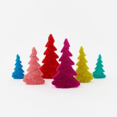 small plastic christmas trees lined up in different colors