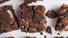 several cookies and oreo brownies on a white surface