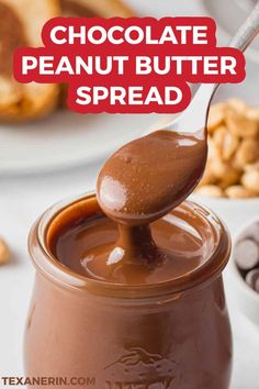 chocolate peanut butter spread is being spooned into a jar with peanuts in the background