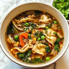 a white bowl filled with soup and vegetables