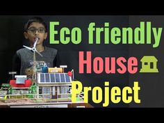 a young boy standing in front of a house made out of lego blocks with the words eco friendly house project