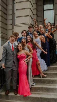 a group of young people standing on steps in front of a building