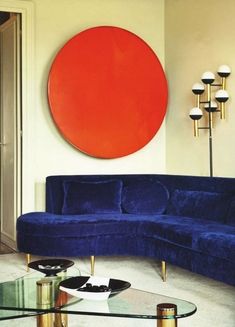 a living room filled with furniture and a large red circle on the wall