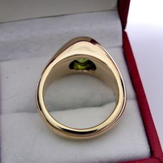 Here is a great ring, set with a very high quality Vivid green AAA grade Peridot. This is genuine natural untreated gemstone. This stone weighs 2.82 carats and measures 9.8 x 7.7 mm. This is a Gem quality stone with no visible inclusions. Great Portuguese cut with lots of brilliance. The color in the first three images is by far the best true representation of the true color of this stone. Color is as shown in the images. This is natural Peridot from Sri Lanka The ring is very solid and has a go Classic Oval Emerald Ring With Tension Setting, Oval Signet Ring With Tension Setting For Anniversary, Classic Oval Signet Ring With Tension Setting, Yellow Gold Oval Signet Ring With Tension Setting, Oval Signet Ring With Tension Setting For Gift, Oval 14k Gold Signet Ring With Tension Setting, Gold Mens Ring, Yellow Gold Mens Rings, Iron Heart