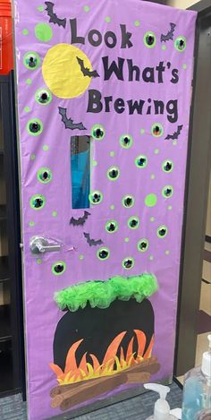 a purple door decorated with halloween decorations and writing that says, look what's brewing