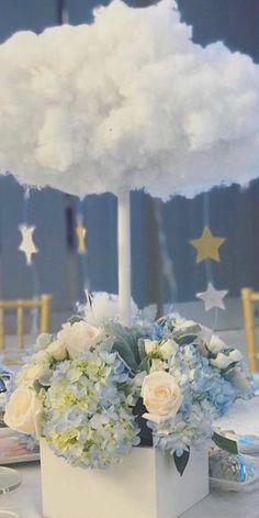 a table topped with a cloud shaped centerpiece