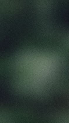 a blurry image of green and black colors