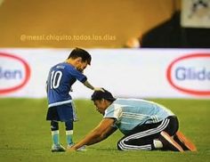 two soccer players are on the field with one holding his knee and another kneeling down