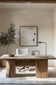 an office with a desk, chair and potted plant