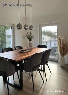 a dining room table with chairs and a vase filled with flowers on top of it