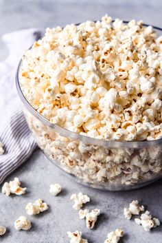 a bowl filled with popcorn sitting on top of a table