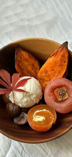 a wooden bowl filled with different types of food on top of a white tablecloth