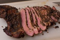 some meat is laying on a cutting board