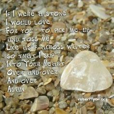 a rock sitting on top of a pile of rocks with a poem written in it