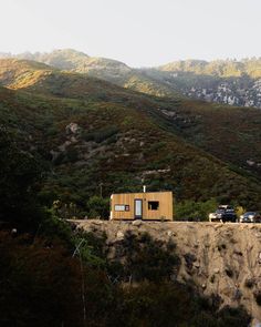 a small house on the side of a mountain