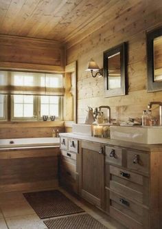 a bathroom with wood paneling and two sinks