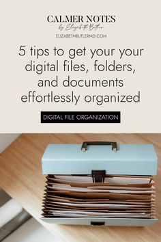 a stack of files sitting on top of a wooden table