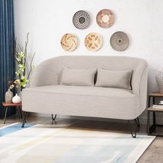 a living room scene with focus on the sofa and pillows in front of the wall