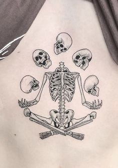 a woman's back with skeleton tattoos on it