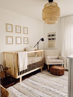 a baby's room with a crib, chair, rug and pictures on the wall