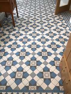 a blue and white tiled floor in a bathroom