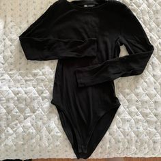 This Is An Unworn Zara Bodysuit In A Black Ribbed Tee Material. Bought In 2019 But Have Worn Less Than Twice Because The Sleeves Are A Little Too Short On Me (I Am 5’8 With Quite Long Arms). Size Medium & Actually Fits True To Size Unlike Some Of Their Other Bodysuits. Perfect Condition & Ready To Style! (: Stretch Ribbed Cotton Bodysuit, Black Ribbed Trendy Bodysuit, Black Long Sleeve Ribbed Bodysuit, Zara Black Stretch Bodysuit, Black Stretch Crew Neck Bodysuit, Black Stretch Bodysuit With Crew Neck, Casual Ribbed Bodysuit For Night Out, Fall Stretch Cotton Bodysuit, Stretch Cotton Bodysuit For Fall