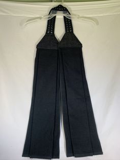 a pair of black pants hanging on a clothes rack