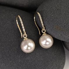 These earrings start with a matched pair of stunning genuine freshwater pearls. They each dangle on custom 14K settings from a line of 5 little pave diamonds, which have been set into solid 14K gold hooks. My favorite thing about these earrings is the way the diamonds and pearls complement and contrast with each other - the large pearls look even more creamy smooth and luminous next to the tiny glittering diamonds. It's a lovely marriage and a perfect balance. The pearls are 9mm genuine, natural freshwater pearls, with 5pts of diamond per earring. Made from solid 14K gold yellow gold.  Shop home: www.lotusstone.etsy.com More handmade earrings: http://www.etsy.com/shop/LotusStone?section_id=6138438 WHAT DOES RECYCLED MEAN? Recycled metal, in this case, is gold and silver that has been recla Diamond And Pearl Earrings, Bell Earrings, Large Pearl Earrings, Gold Hooks, Diamonds And Pearls, Yellow Gold Bangle, Pearl And Diamond Earrings, Solid Gold Earrings, Indian Earrings