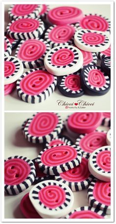 some pink and black buttons sitting on top of each other